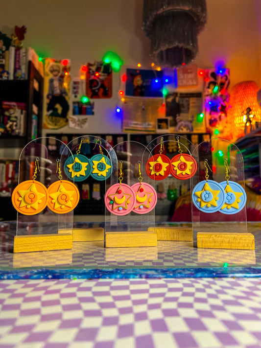 Handmade anime-inspired earring collection with moon and planet details